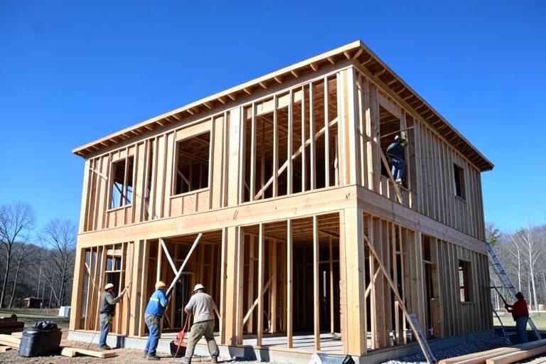 Crew framing a two-story home addition